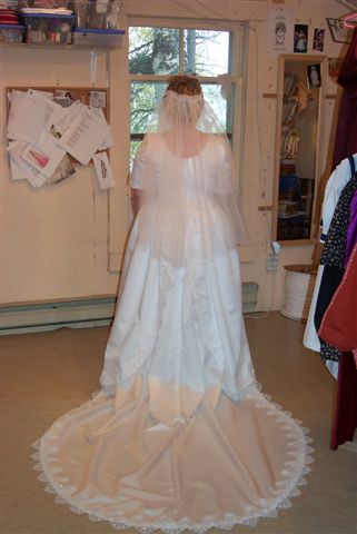 Satin gown with split back & lace trimmed train
