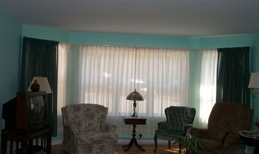 Large bay window..green sheer open over ivory sheer
